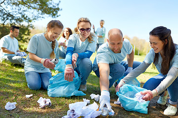 Image showing volunteers with garbage bags cleaning park area