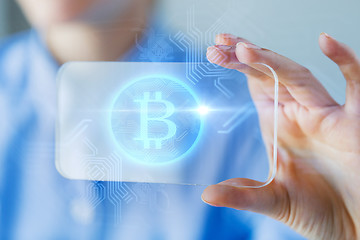 Image showing close up of bitcoin on transparent smartphone