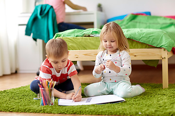 Image showing happy kids drawing at home