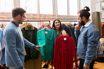 Image showing friends choosing clothes at vintage clothing store