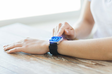 Image showing close up of hands with bitcoin on smart watch