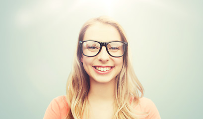 Image showing happy young woman or teenage girl in eyeglasses