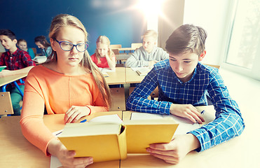 Image showing students reading book at school lesson