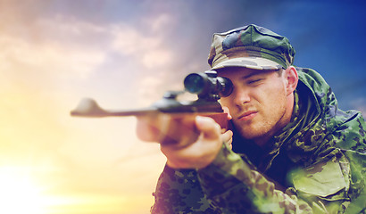 Image showing soldier or hunter with gun aiming and shooting