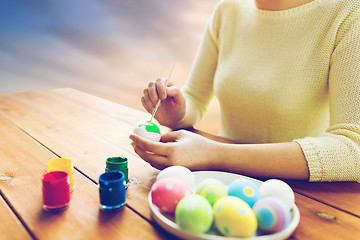 Image showing close up of woman hands coloring easter eggs