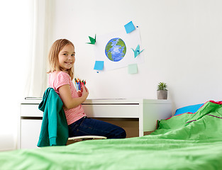 Image showing happy girl doing homework or drawing at home