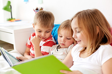 Image showing little kids reading book in bed at home