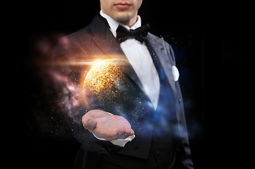 Image showing male magician with planet and space hologram