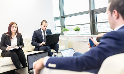 Image showing Business people sitting at working meeting in modern corporate office.