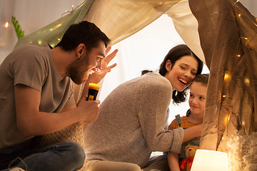 Image showing father telling scary stories to his daughter