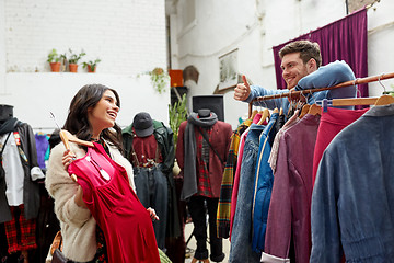 Image showing couple choosing clothes at vintage clothing store