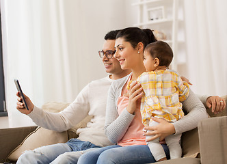 Image showing mother, father and baby with tablet pc at home