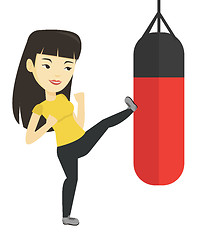 Image showing Woman exercising with punching bag.