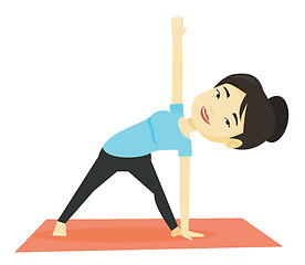 Image showing Woman practicing yoga triangle pose.