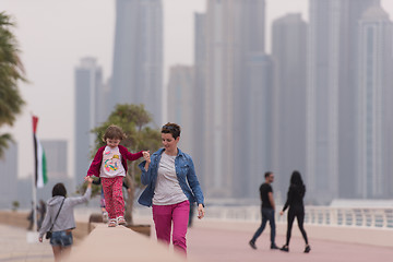 Image showing mother and cute little girl on the promenade