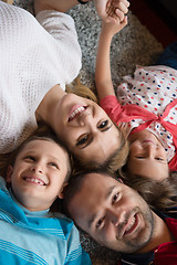 Image showing happy family lying on the floor