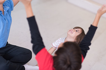 Image showing young boys having fun on the floor