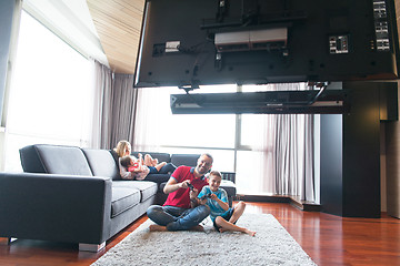 Image showing Happy family playing a video game