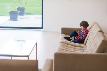 Image showing little girl playing games on smartphone