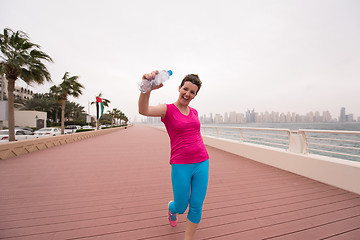 Image showing young woman celebrating a successful training run