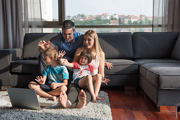 Image showing Family Playing Together with laptop computer