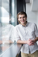 Image showing young businessman in startup office by the window