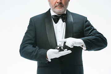 Image showing Senior waiter holding bell