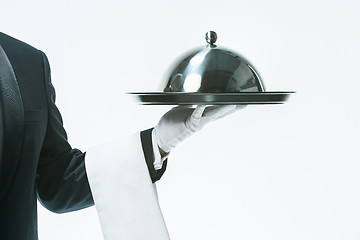 Image showing Close up waiter hand with tray and metal cloche lid cover