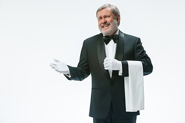 Image showing Senior waiter holding white towel