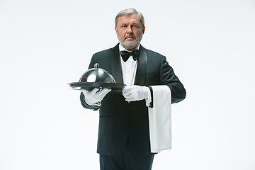 Image showing Senior waiter holding tray