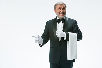 Image showing Senior waiter holding white towel