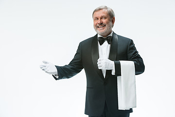 Image showing Senior waiter holding white towel