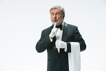 Image showing Senior waiter holding white towel