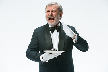 Image showing Senior waiter holding bell