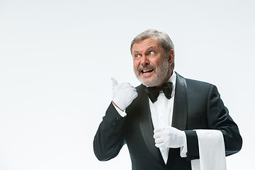 Image showing Senior waiter holding white towel