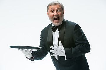 Image showing Senior waiter holding tray