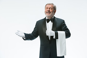 Image showing Senior waiter holding white towel