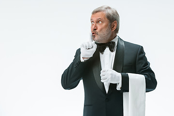 Image showing Senior waiter holding white towel