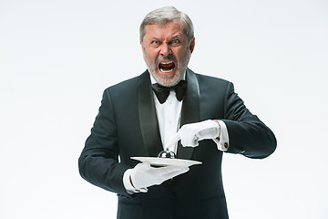 Image showing Senior waiter holding bell