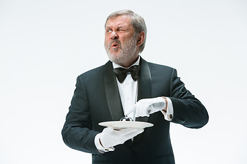 Image showing Senior waiter holding bell