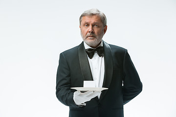 Image showing Senior waiter holding tray