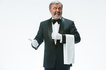 Image showing Senior waiter holding white towel