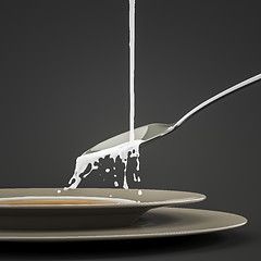 Image showing milk splashing at the spoon