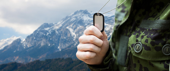 Image showing close up of young soldier with military badge