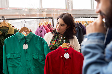 Image showing couple choosing clothes at vintage clothing store