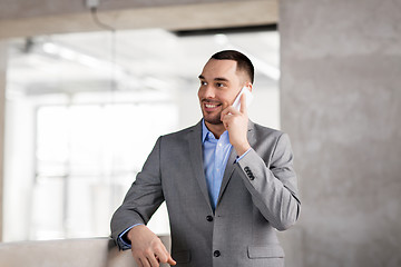 Image showing businessman calling on smartphone at office