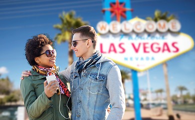 Image showing couple with smartphone and earphones at las vegas