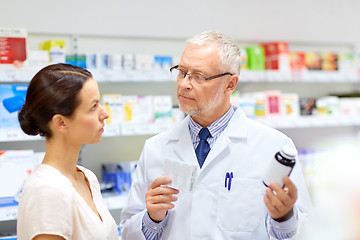 Image showing apothecary and woman with drug at pharmacy