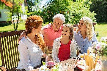 Image showing happy family having dinner at summer garden