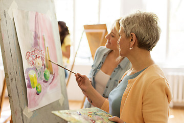 Image showing women with brushes painting at art school